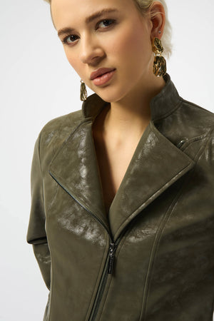 Woman wearing a green leather jacket on a plain background